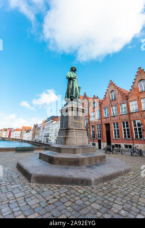 Monument of famous artist Jan Van Eyck on Square Jan van Eyckplein in Bruges, Belgium. Stock Photo