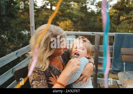 Mother brushing daughters teeth Stock Photo