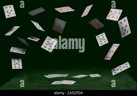 playing cards on green table on a dark background Stock Photo