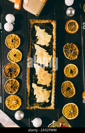Freshly baked christmas tart  on a wooden background with various christmas decoration Stock Photo