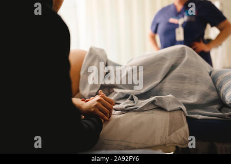 Woman with partner in delivery room Stock Photo