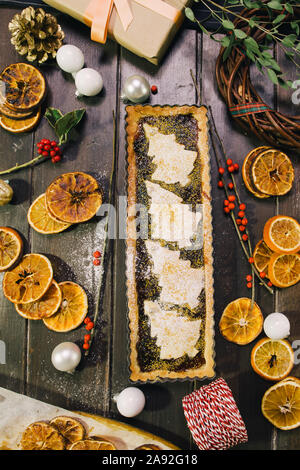 Freshly baked christmas tart  on a wooden background with various christmas decoration Stock Photo