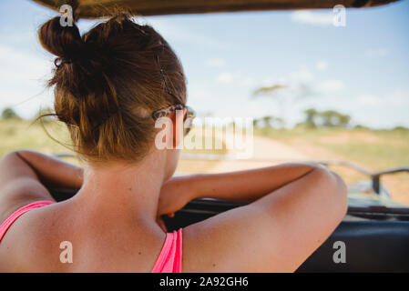 Woman in car looking at view Stock Photo