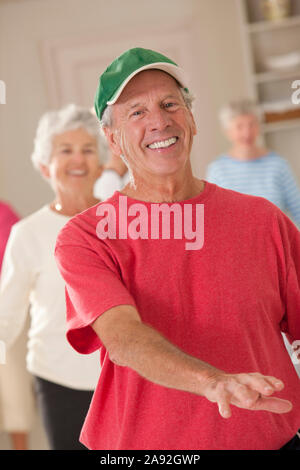 Seniors exercising in a health club Stock Photo