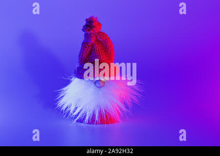 Modern conceptual art Santa with shadow in duotone pink and blue lights. Christmas decoration with copy space, greering card concept Stock Photo