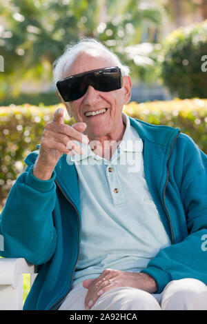 Senior man wearing cataract dark glasses Stock Photo