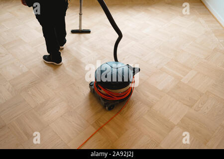 Vacuuming parquet floor Stock Photo