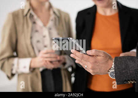 Businessmans hand holding digital tablet Stock Photo