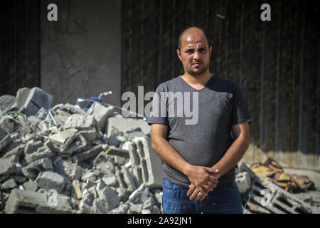 Tel Aviv, Palestinian Territories. 12th Nov, 2019. The neighbour Ahmad Helles stands in front of the house of the Islamic Jihad leader Baha Abu Al Ata, which was damaged after an Israeli air raid. Israel's security forces have taken targeted action to kill the military chief of Islamic Jihad in the Gaza Strip. Israel declared that it would not return to a policy of targeted killing. According to the army, this had been a unique action to avert 'a direct threat'. Credit: Saud Abu Ramadan/dpa/Alamy Live News Stock Photo