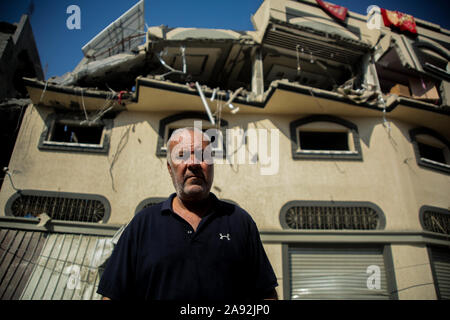 Tel Aviv, Palestinian Territories. 12th Nov, 2019. The neighbour Sami Helles stands in front of the house of the Islamic Jihad leader Baha Abu Al Ata, which was damaged after an Israeli air raid. Israel's security forces have taken targeted action to kill the military chief of Islamic Jihad in the Gaza Strip. Israel declared that it would not return to a policy of targeted killing. According to the army, this had been a unique action to avert 'a direct threat'. Credit: Saud Abu Ramadan/dpa/Alamy Live News Stock Photo