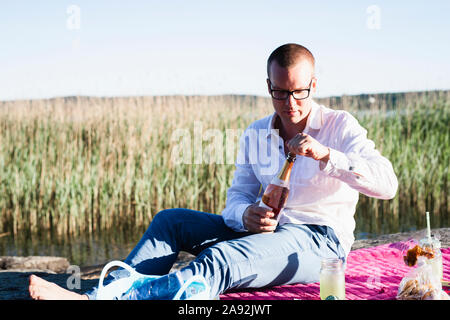 Man opening champagne Stock Photo
