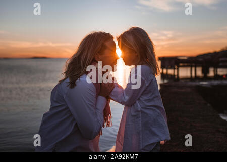 Mother and daughter at sunset Stock Photo