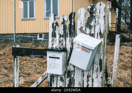 Mailboxes on wooden fence Stock Photo