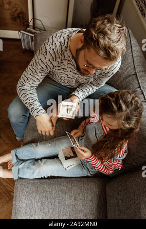 Father and daughter looking at pictures Stock Photo