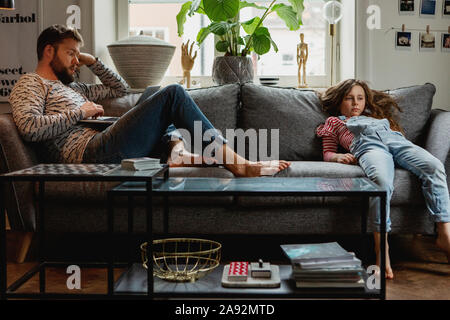 Father and daughter on sofa Stock Photo
