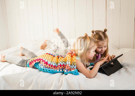 Girls using digital tablet Stock Photo