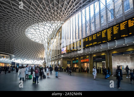 Interior of London King's Cross railway station with travellers and shops; London, England Stock Photo