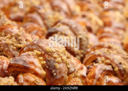 Fresh croissant  with nuts and icing in the cake shop Stock Photo