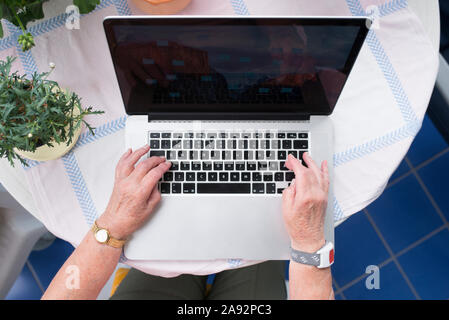 Senior woman using laptop Stock Photo