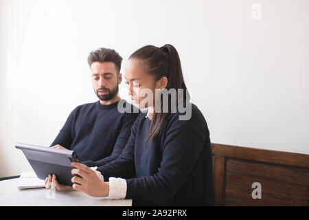 Couple in cafe using digital tablet Stock Photo