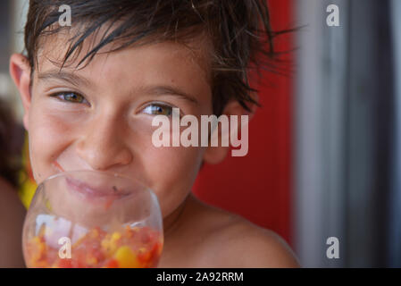 Little boy drinking juice fruit to the beach restaurant at Le Pin de Galle Le Pradet f 83 Stock Photo