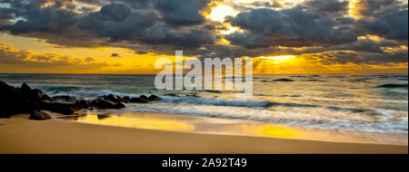 Sunrise from a beach on the coast of Kauai; Kauai, Hawaii, United States of America Stock Photo