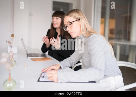 Two women working in office Stock Photo