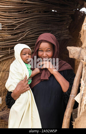 Sudanese woman holding a baby; Kokka, Northern State, Sudan Stock Photo