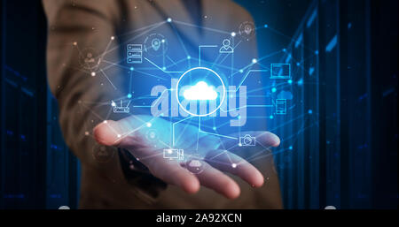 Man holding hologram projection displaying cloud technology symbols Stock Photo