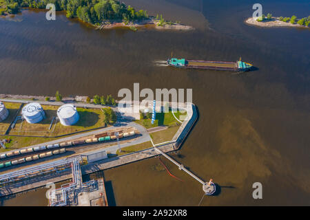 Aerial view of large fuel storage tanks at oil refinery industrial zone in the cargo seaport Stock Photo