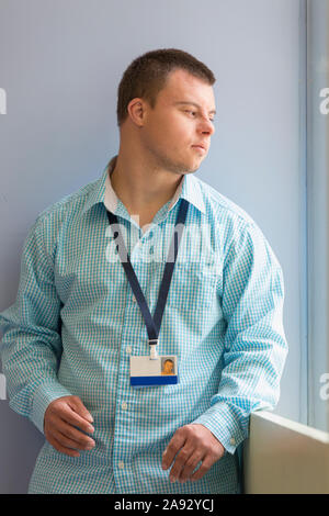 Young man with Down Syndrome working as a hospital aid Stock Photo