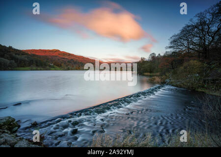 Long exposure image of the weir at Grasmere in the English Lake District National Park. at dawn on a clear autumn day.