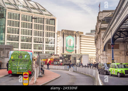 Exterior view of the Apollo Victoria Theatre advertising the musical production Wicked outside busy London Victoria train station. Stock Photo