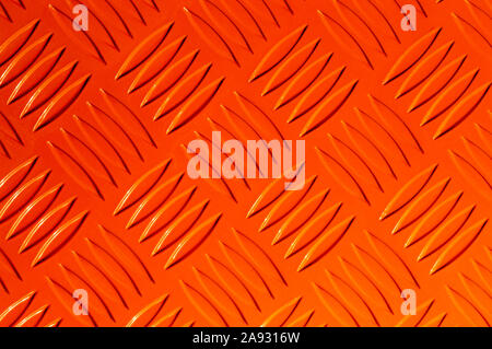 Textured metal embossed orange background. Front view Stock Photo