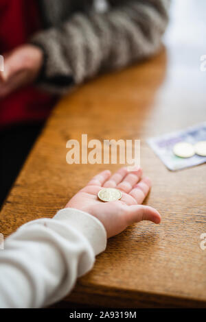 Hand holding coin Stock Photo