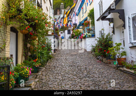 Devon, UK - August 2nd 2019: A view up the picturesque cobbled main street of the fishing village of Clovelly in North Devon, UK. Stock Photo