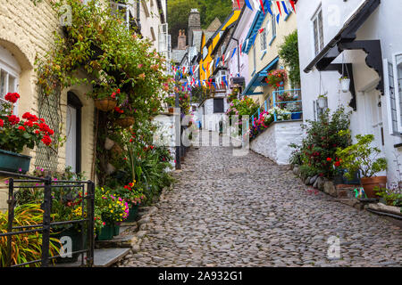 Devon, UK - August 2nd 2019: A view up the picturesque cobbled main street of the fishing village of Clovelly in North Devon, UK. Stock Photo