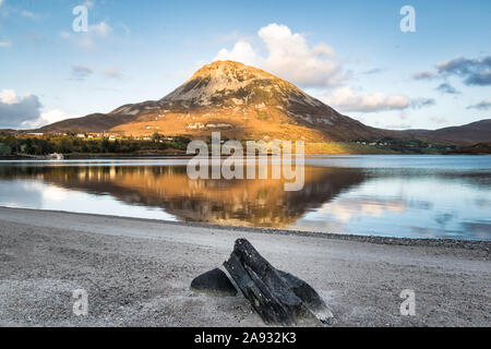 Errigal Mountain in Donegal Ireland being reflected in a lake in front of the mountain Stock Photo