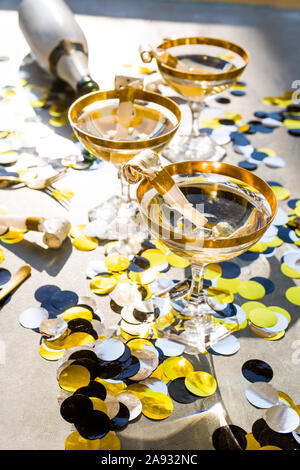 Champagne party 2020 new year conceptual image, elegant glass of champagne with a bottle , top view, hard light, christmas decoration, strong shadow. Stock Photo