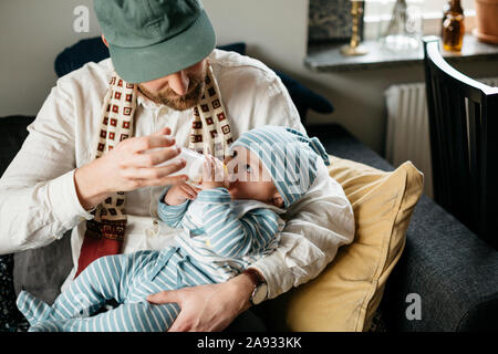 Father feeding baby Stock Photo