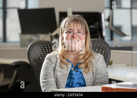 Young woman with Down Syndrome working in an office Stock Photo