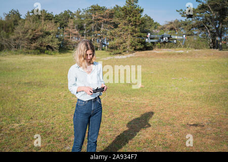 Woman flying drone Stock Photo
