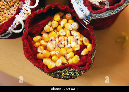 corn seeds . Corn seeds in burlap . Close up dry corn kernels in hemp sacks, taoke a photo on top view . tasacks with autumn agricultural harvest - Stock Photo