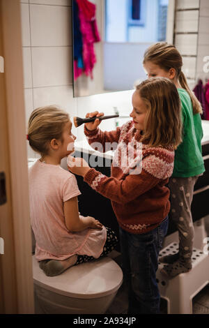 Girl putting make-up on Stock Photo