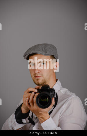 Young man using a professional camera in studio Stock Photo
