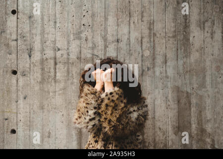 Woman covering her face Stock Photo