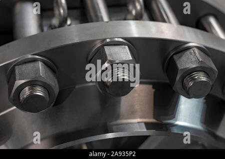 Metal nuts attract flange studs. Close up. Front view. Stock Photo