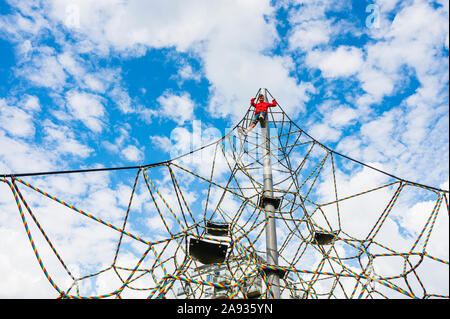 Boy on climbing frame Stock Photo