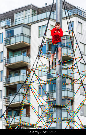 Boy on climbing frame Stock Photo