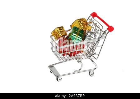 One shopping cart loaded with gift boxes isolated on white background. Stock Photo